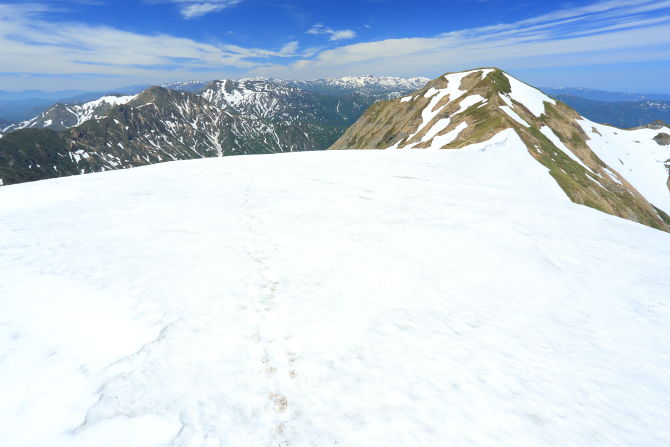 一の倉岳～茂倉岳鞍部に横たわる雪渓を越えて。陽射しが反射して眩しい